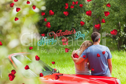 Composite image of loving couple admiring nature while leaning o