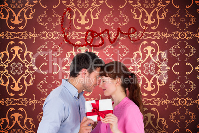 Composite image of loving couple holding a gift