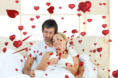 Composite image of positive couple drinking coffee lying in the