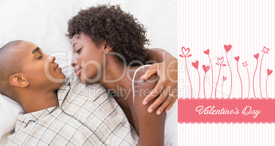 Composite image of happy couple sleeping in bed together