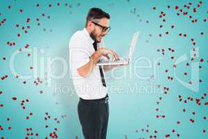 Composite image of geeky businessman using his laptop