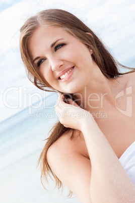 smiling young brunette woman in summer on the beach