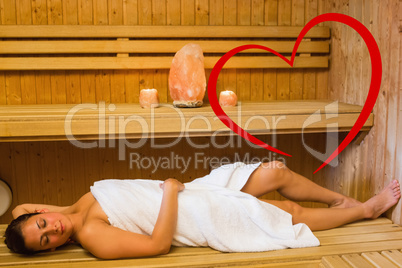 Composite image of happy brunette woman lying in a sauna