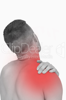 Rear view of shirtless man with shoulder pain