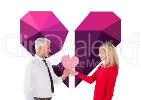 Composite image of handsome man getting a heart card form wife