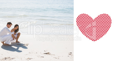 Composite image of cute couple drawing a heart in the sand