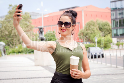 attractive young woman with smartphone and sunglasses outdoor