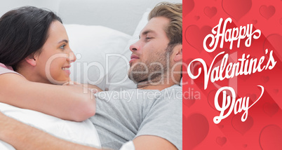 Composite image of couple awaking and looking at each other