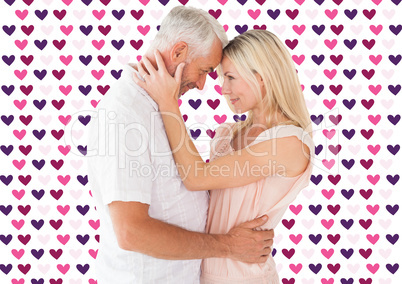 Composite image of affectionate couple standing and hugging