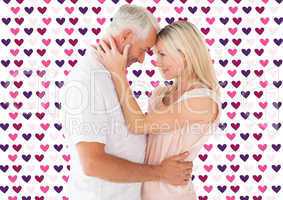 Composite image of affectionate couple standing and hugging