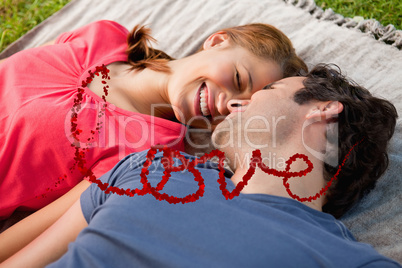 Composite image of woman smiling while lying next to her friend