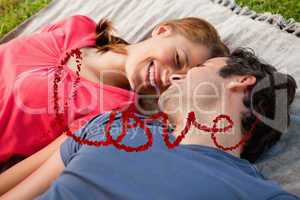 Composite image of woman smiling while lying next to her friend