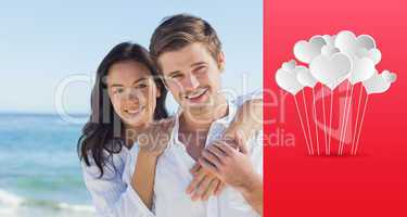 Composite image of cheerful couple embracing on the beach