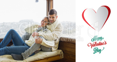 Composite image of couple in winter clothing sitting against cab