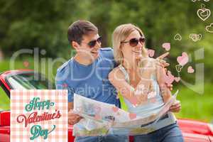 Composite image of cheerful young couple reading map