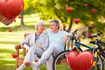 Composite image of elderly couple with their bikes