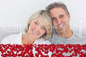 Composite image of cheerful couple in bed