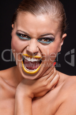 attractive young woman scream out loud with yellow lipstick