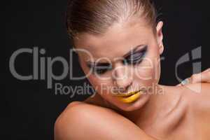 woman with extreme colorfull make up in blue and yellow