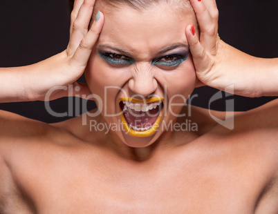attractive young woman scream out loud with yellow lipstick
