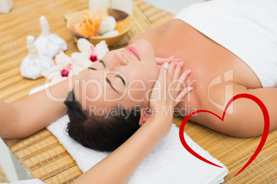 Composite image of smiling brunette enjoying a head massage