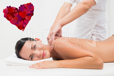 Composite image of beautiful brunette enjoying a back massage sm