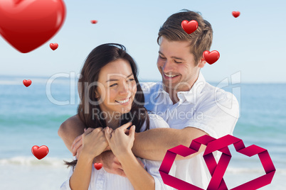 Composite image of cheerful couple relaxing on the beach during