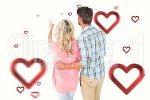 Composite image of attractive couple standing and looking