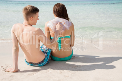 Man drawing a heart on his girlfriends back