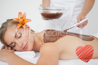 Composite image of beautiful blonde enjoying a chocolate beauty