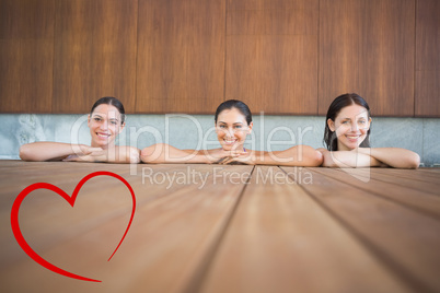 Composite image of cheerful young women in swimming pool