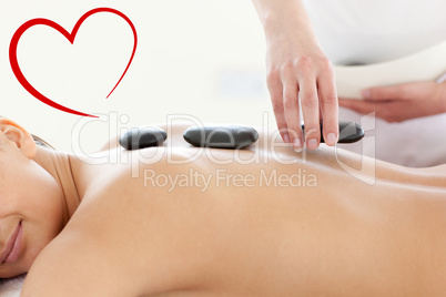 Composite image of portrait of a beautiful woman having a massag