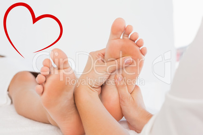 Composite image of close-up of a woman receiving foot massage
