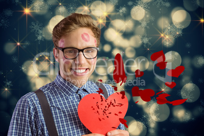 Composite image of geeky hipster covered in kisses