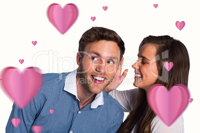 Composite image of happy young woman whispering secret into frie