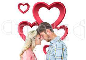 Composite image of attractive couple standing touching heads