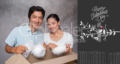 Composite image of happy couple unpacking moving boxes