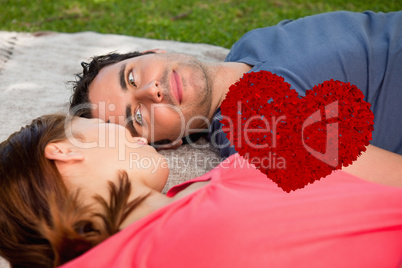 Composite image of man looking into his friends eyes while lying