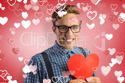 Composite image of geeky hipster covered in kisses