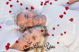Composite image of high angle portrait of a mature couple lying
