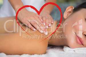 Composite image of content brunette getting a back massage
