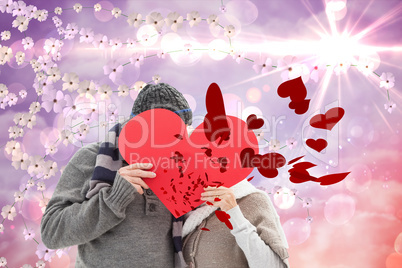 Composite image of happy mature couple in winter clothes holding