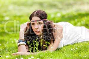 Pretty young woman in a headband daydreaming