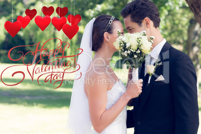 Composite image of couple kissing behind bouquet in garden