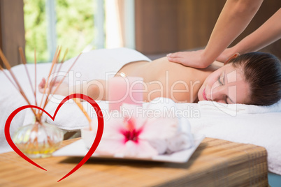 Composite image of attractive woman receiving back massage at sp