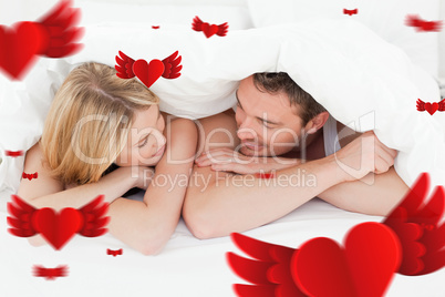 Composite image of lovely couple in their bed