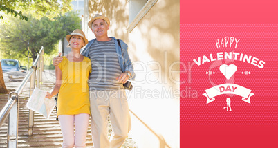 Composite image of happy tourist couple walking in the city