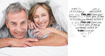 Composite image of loving couple under the duvet