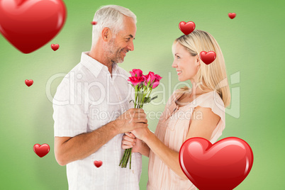 Composite image of affectionate man offering his partner roses