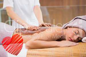 Composite image of attractive woman receiving chocolate back mas